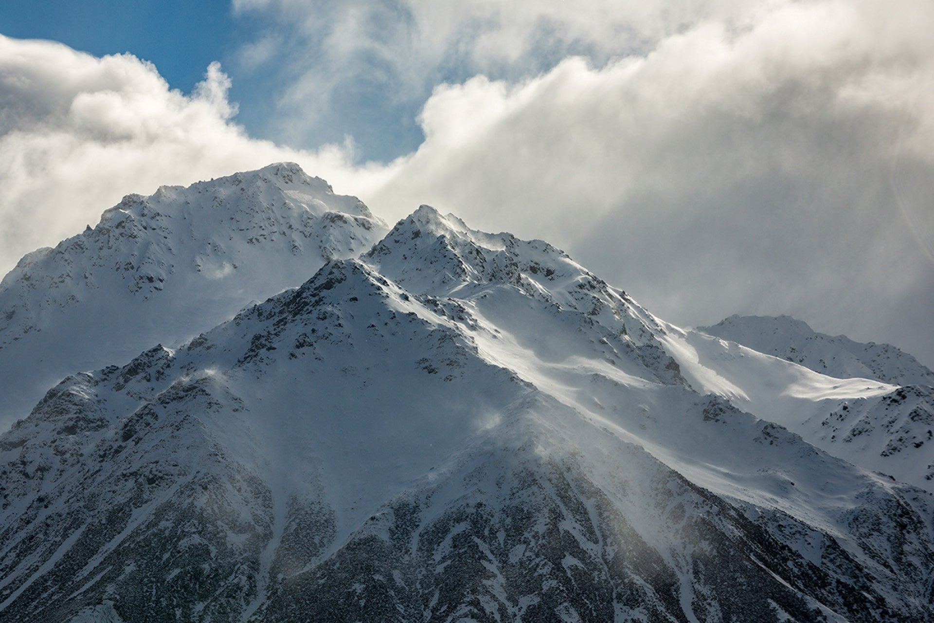 Force of a Nor-Wester driving snow from ridges in New Zealand's Dobson River Valley, Southern Alps, with an impending storm, captured by photographer Steve Couper – ideal for wild weather admirers seeking Aotearoa's natural beauty.
