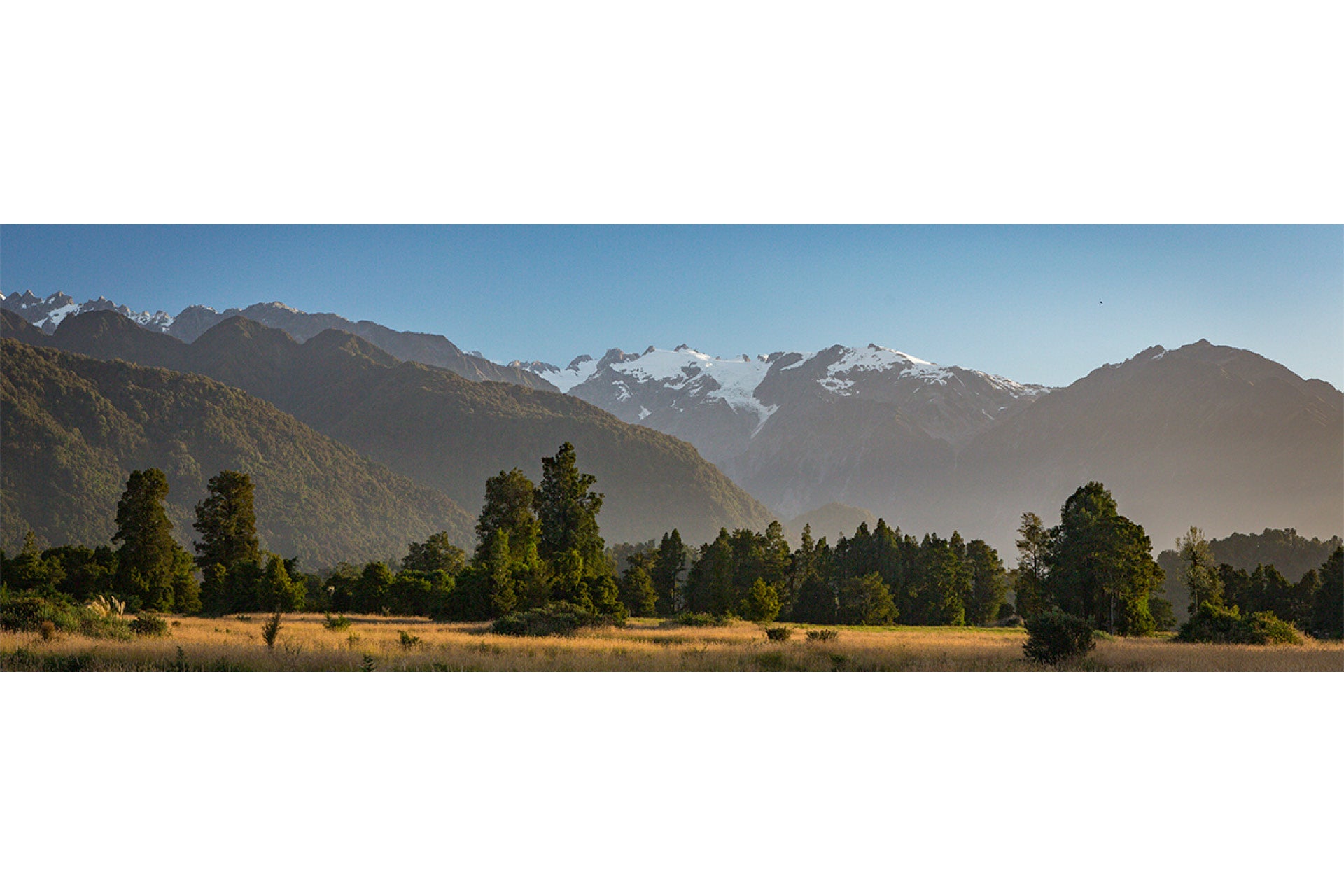 Awe-inspiring Franz Josef Glacier Southern Alps West Coast New Zealand, with towering peaks framing ancient ice flows in Westland Tai Poutini National Park